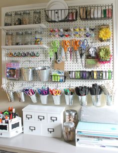 an organized peg board with craft supplies on it