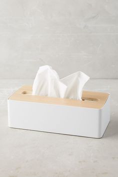 a white tissue dispenser sitting on top of a counter