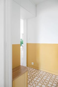 an empty room with yellow and white walls