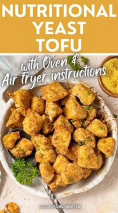 a plate full of fried tofu on top of a table with other food items