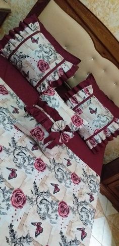 a bed with red and white bedspreads on top of it