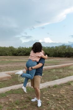 a man holding a woman in his arms