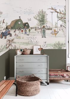 a child's room with wallpaper and toys in the corner, including a toy chest