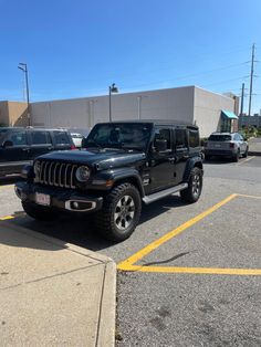 a black jeep parked in a parking lot