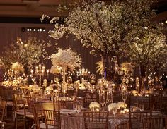 the tables are set up with gold linens and centerpieces for an elegant wedding