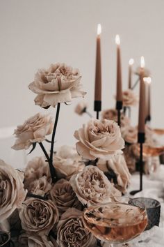 flowers and candles are sitting on the table