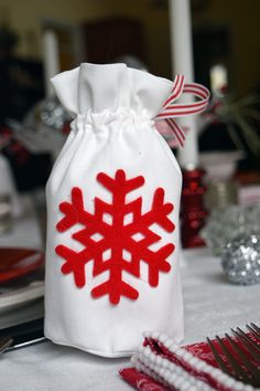 a white bag with a red snowflake on it sitting on top of a table