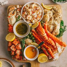 seafood platter with lobsters, crab legs, and shrimp on a cutting board