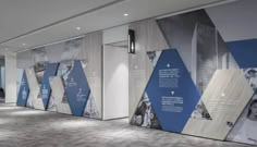 an office lobby with large wall graphics on the walls and carpeted flooring in front of it