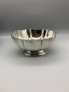 a silver bowl sitting on top of a table