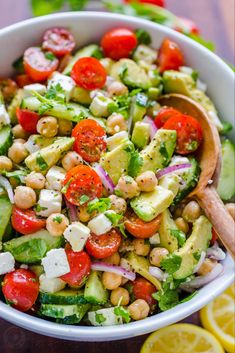 a salad with cucumber, tomatoes and chickpeas