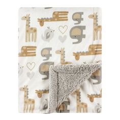 a blanket with giraffes and hearts on it