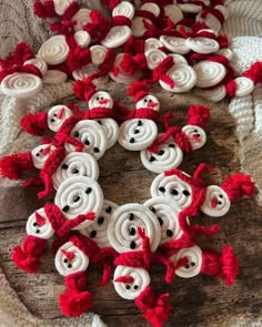 some red and white crocheted buttons on a wooden board