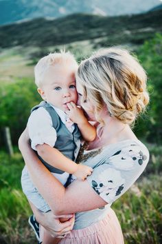 a woman holding a small child in her arms