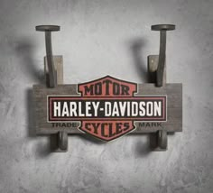 the harley davidson sign is mounted on a wall