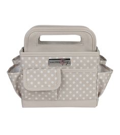 a white and gray polka dot purse with two pockets on the front, one has a handle