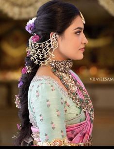 a woman with long hair and jewelry on her head