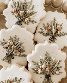 four decorated cookies sitting on top of a table