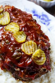 a close up of food on a plate with mashed potatoes and meatloaf