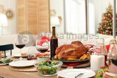 a table set for christmas dinner with turkey and wine