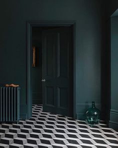 a black and white checkered floor in an empty room with a radiator