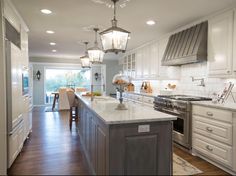 a large kitchen with an island in the middle