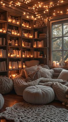 a living room filled with lots of furniture and bookshelves covered in candles next to a window