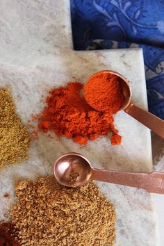 spices and spoons on a marble counter top