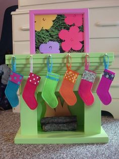 christmas stockings hanging from the fireplace in front of a framed flowered wall art piece