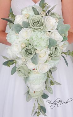 a bridal holding a bouquet of white and green flowers