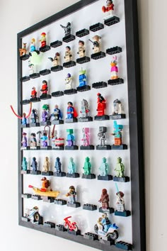 legos are arranged on the wall to display their individual figures in this unique display