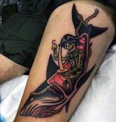 a man with a pirate tattoo on his leg