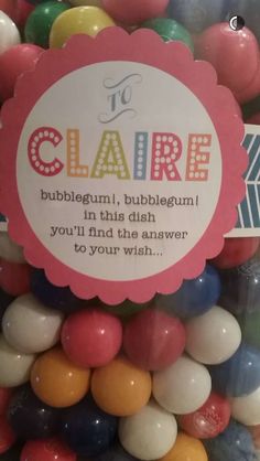 there is a sign that says it's claire in the middle of some gummy balls