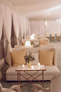 a room filled with lots of white couches and chairs