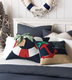 a bed with two pillows on top of it and a wreath above the headboard