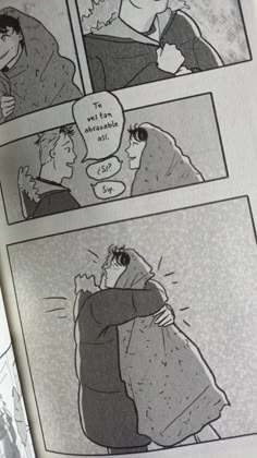 an open comic book with black and white illustrations on it's pages, depicting two people hugging each other