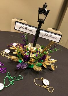 a table topped with lots of jewelry and a street sign on top of it's pole