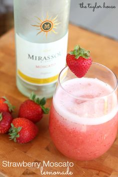 the strawberry moscato is garnished with fresh strawberries on the table