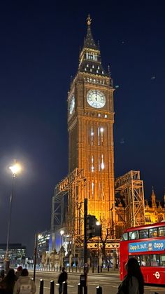 the big ben clock tower towering over the city of london, england at night time