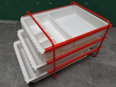 three red and white trays stacked on top of each other