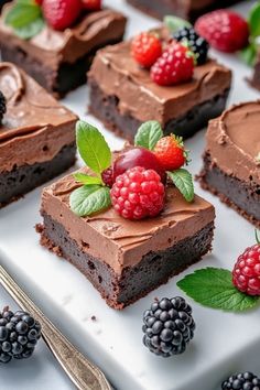 chocolate desserts with raspberries and blackberries on a white platter