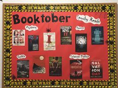 a bulletin board with books written on it in black and yellow lettering, including the words booktober