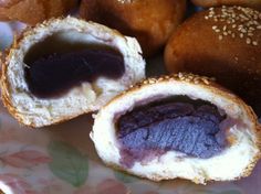 there are several pastries on the plate and one is filled with jelly inside it