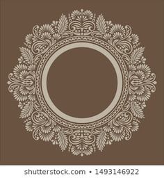 a brown and white circular frame with an ornate pattern on the bottom, in front of a