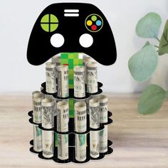 a pile of money sitting next to a game controller