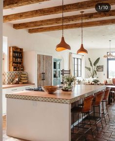 a large kitchen with an island in the middle and lots of counter space on one side