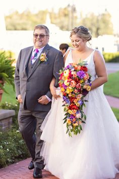 a bride and her father walking down the aisle after their wedding ceremony at disney's animal kingdom