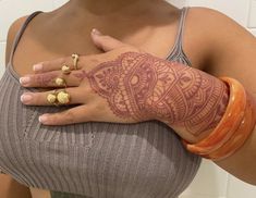 a woman's arm with henna tattoos on it