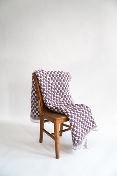 a chair with a checkered blanket on it