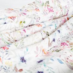 a white sheet with colorful flowers on it